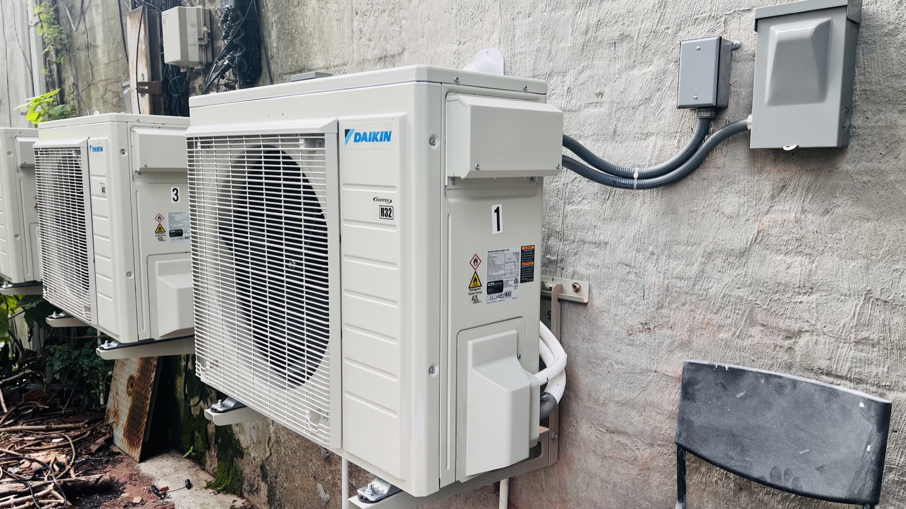 New Daikin multi-zone outdoor heat-pump units installed along an exterior wall